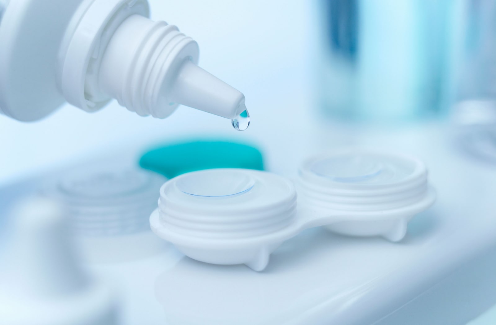 A close-up of contact lenses in a contact lens container and a contact solution filling the containers to disinfect and proper storage