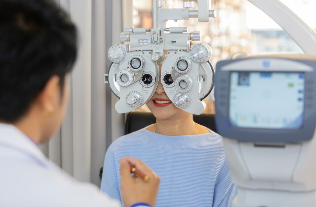 A female patient getting her eyes examined by a male optometrist.