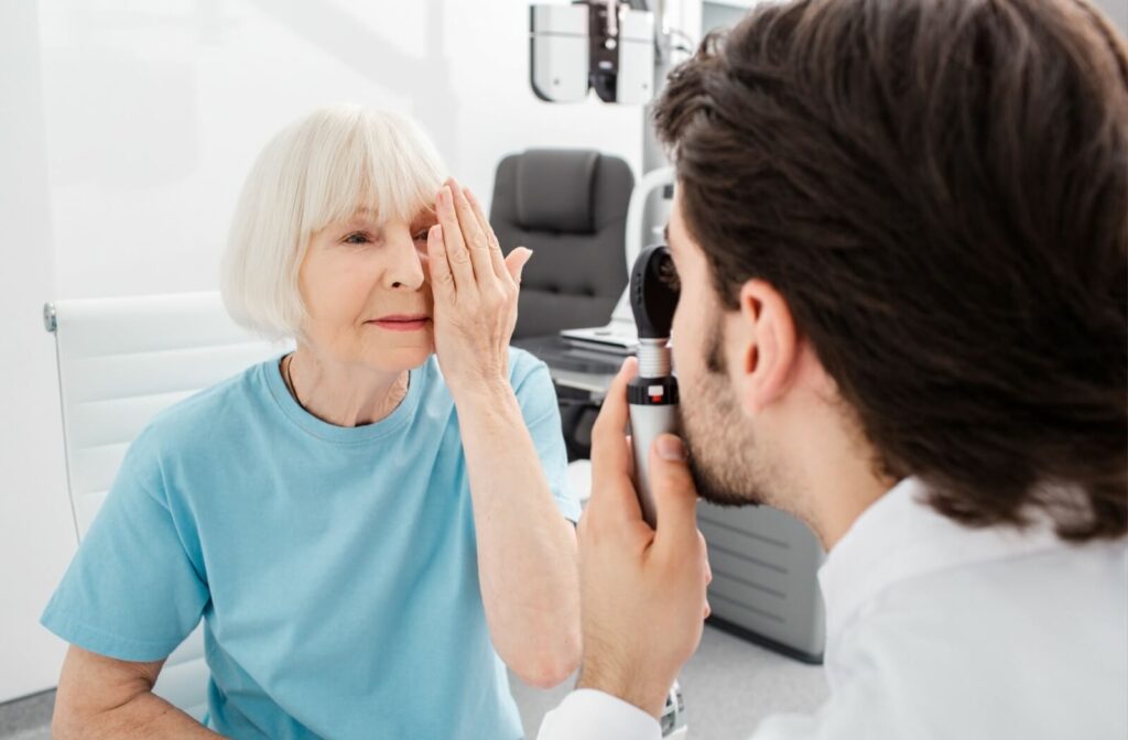  A male optometrist examining the eyes of his female patient.