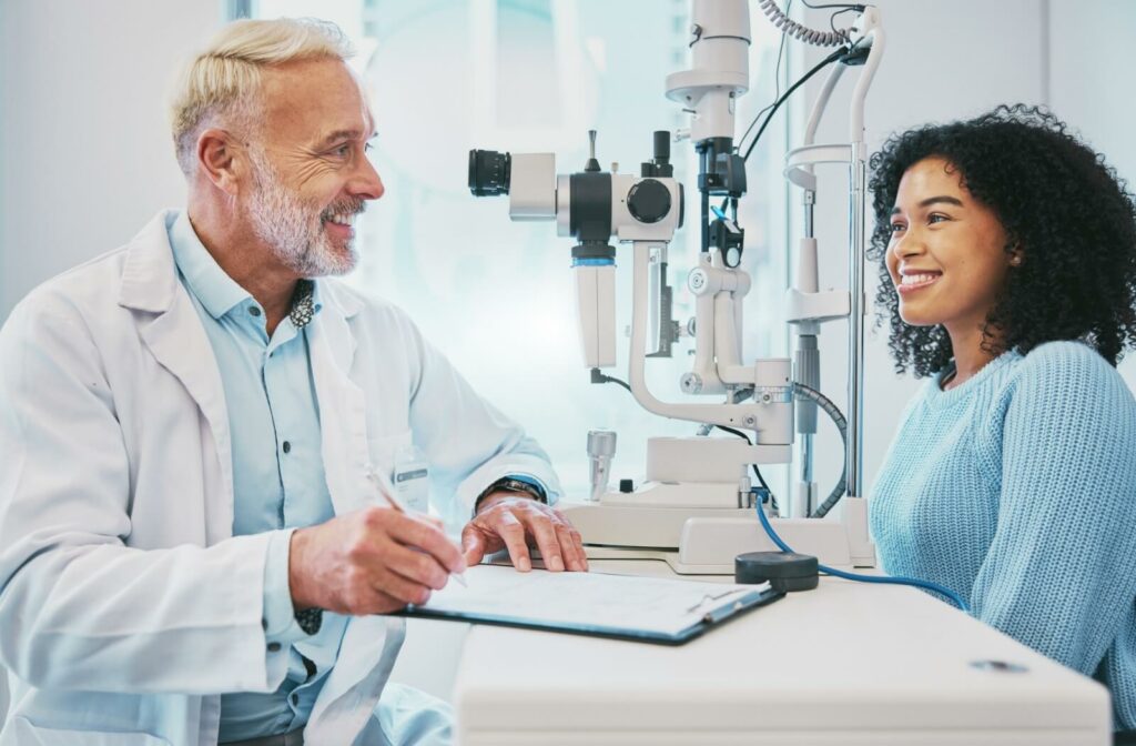 An optometrist talks with a patient about RGP contact lenses