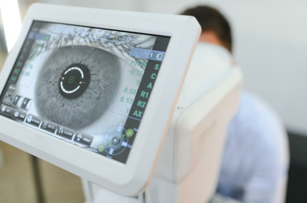 A monitor showing a close-up scan of a person's eye during a comprehensive eye exam.