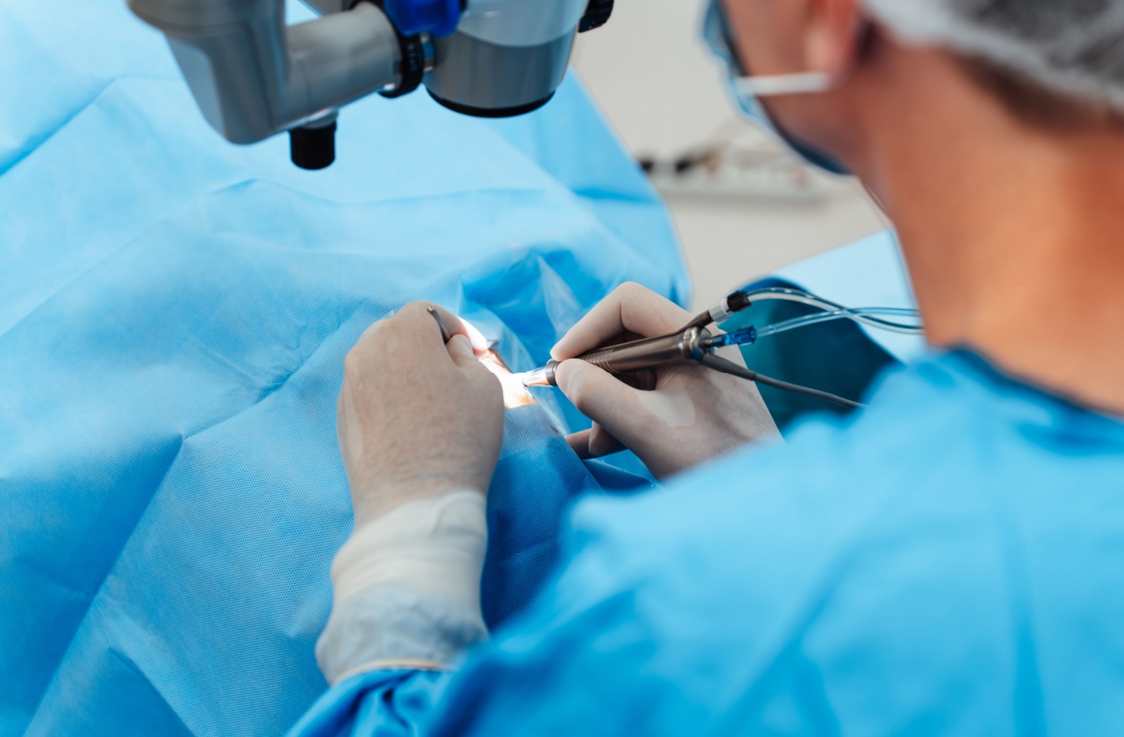 An eye surgeon performing laser eye surgery on a patient.